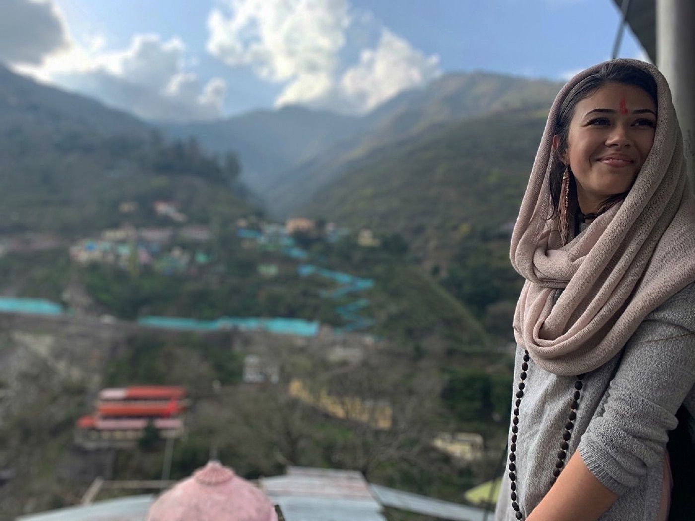 Brittany in India with mountains behind her